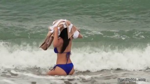 Latina in bikini on the beach has fun